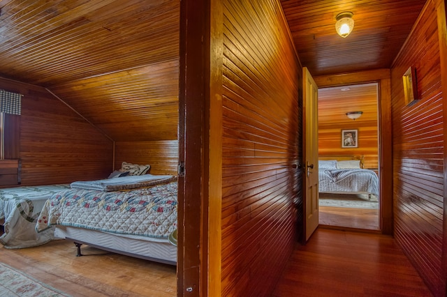 bedroom featuring wood ceiling, wooden walls, and wood-type flooring