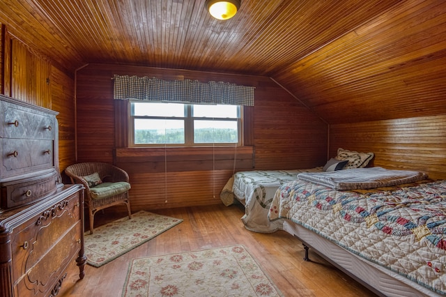 bedroom with light hardwood / wood-style flooring, wooden ceiling, lofted ceiling, and wooden walls