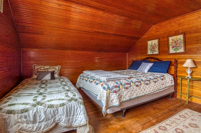 bedroom with hardwood / wood-style floors, lofted ceiling, wood ceiling, and wooden walls