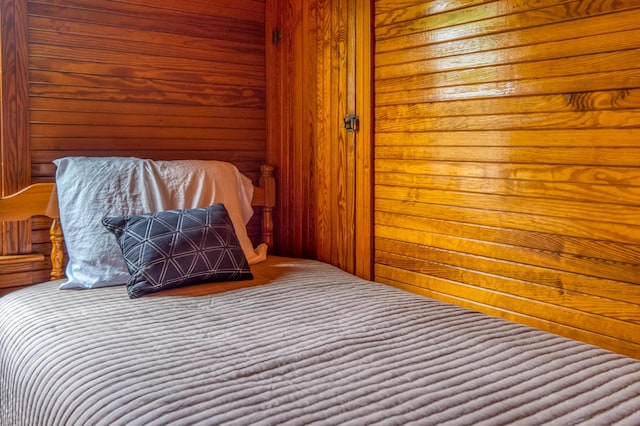 unfurnished bedroom featuring wood walls