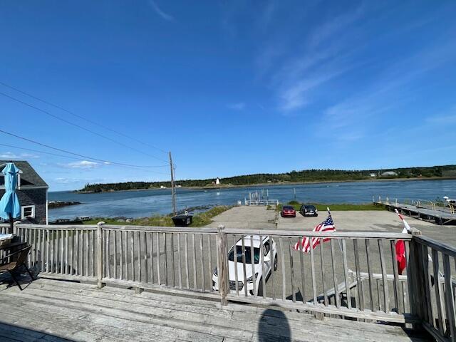 wooden terrace featuring a water view