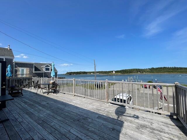 wooden deck featuring a water view