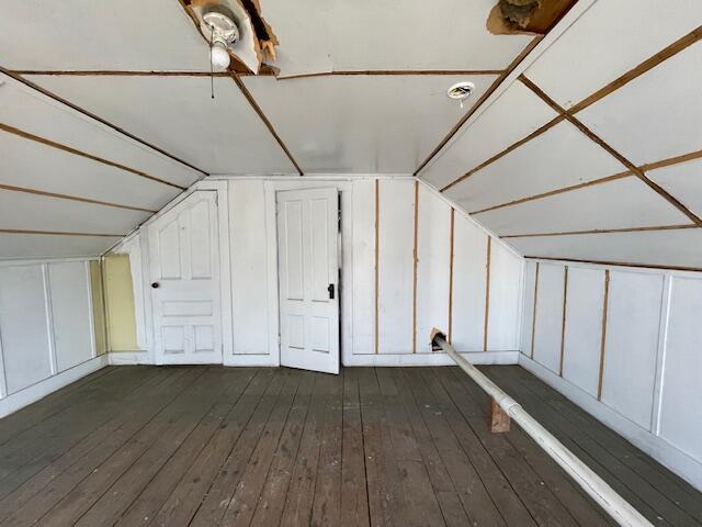 bonus room with hardwood / wood-style flooring and vaulted ceiling