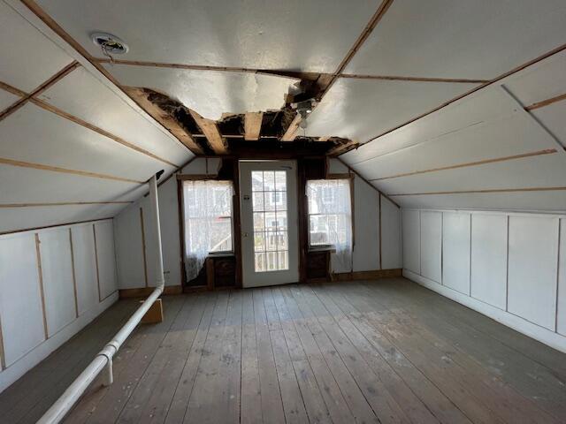 bonus room with lofted ceiling and wood-type flooring