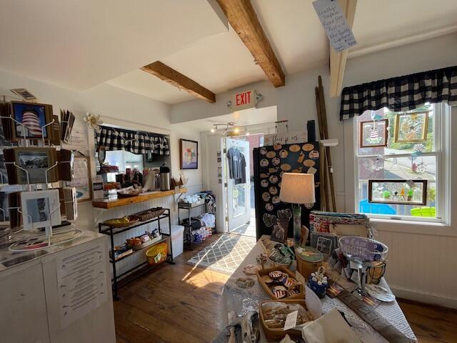 interior space featuring beam ceiling and hardwood / wood-style flooring