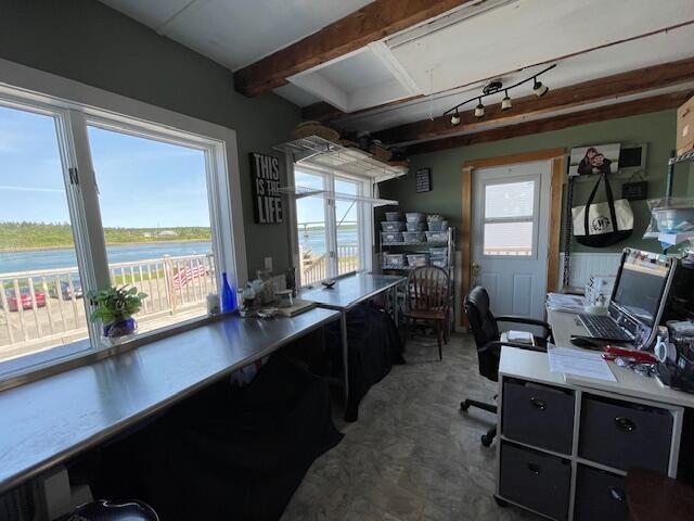 office with beamed ceiling and a water view