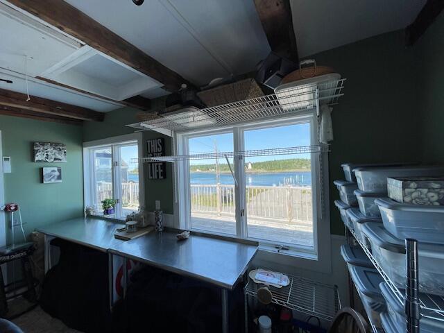 office featuring a water view and beam ceiling