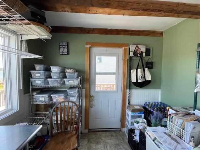 kitchen featuring beam ceiling and tile patterned flooring