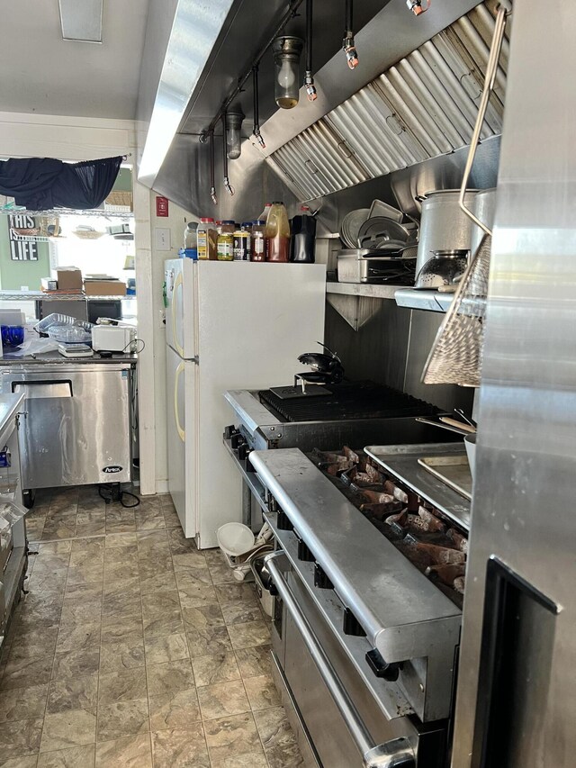 kitchen with tile patterned flooring and white refrigerator