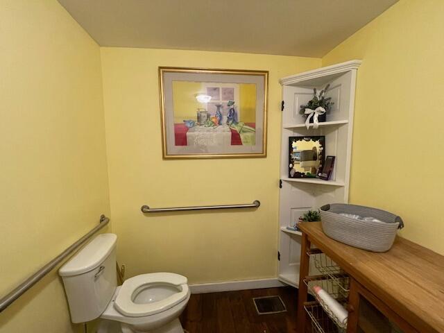 bathroom with toilet and hardwood / wood-style floors