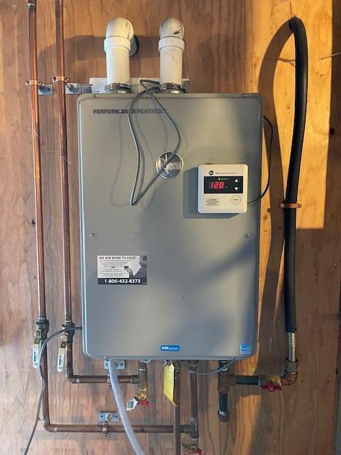 utility room featuring water heater