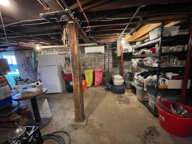 basement with white refrigerator