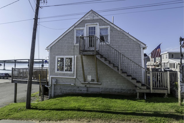 20 Water St Unit 2, Lubec, ME 04652 - view of side of home with a lawn, stairs, and a deck with water view