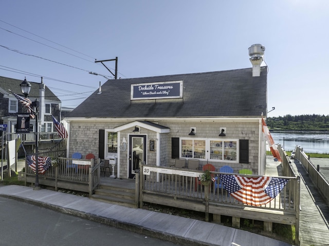 20 Water St Unit 2, Lubec, ME 04652 - view of front of house with a deck with water view and a shingled roof