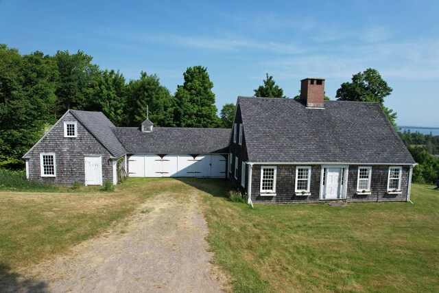38 Kingsbury Ln, Perry, ME 04667 - cape cod-style house featuring a chimney, a front yard, dirt driveway, and roof with shingles
