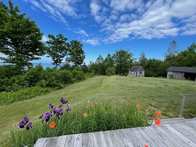 38 Kingsbury Ln, Perry, ME 04667 - view of grassy yard with an outbuilding and a deck