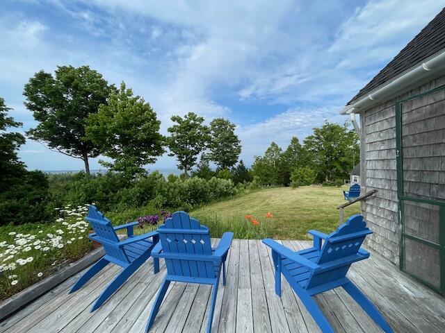 38 Kingsbury Ln, Perry, ME 04667 - wooden deck featuring a yard and view of scattered trees