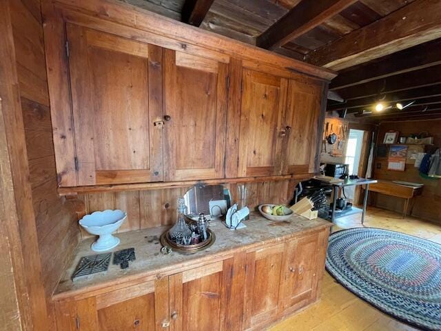 38 Kingsbury Ln, Perry, ME 04667 - miscellaneous room featuring wood finished floors, wooden walls, and beam ceiling