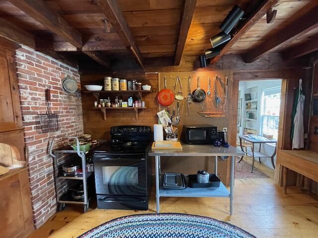 38 Kingsbury Ln, Perry, ME 04667 - bar area with black appliances, a wooden ceiling with exposed beams, and wood walls