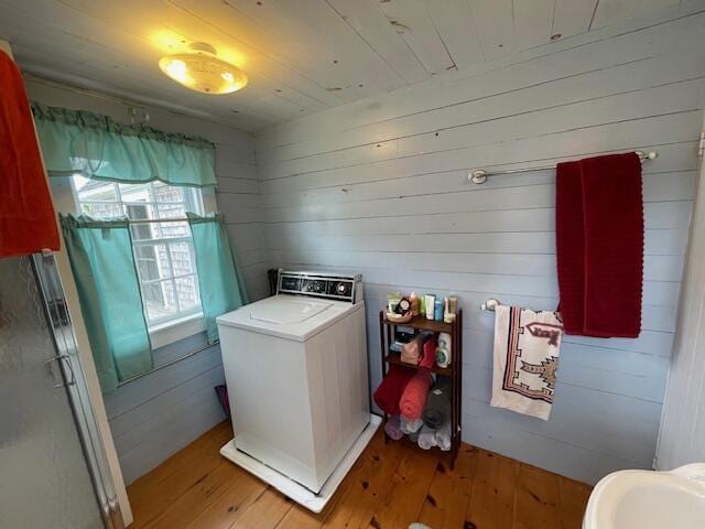 38 Kingsbury Ln, Perry, ME 04667 - laundry room with washer / clothes dryer, light wood-type flooring, and wooden walls