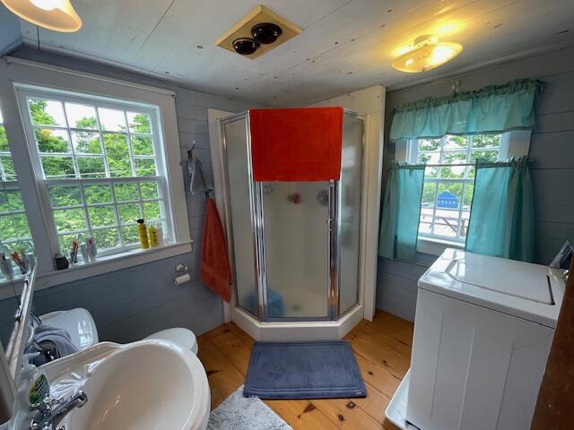 38 Kingsbury Ln, Perry, ME 04667 - full bathroom with healthy amount of natural light, washer / clothes dryer, and wood finished floors
