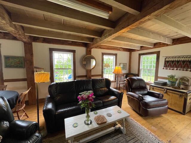 38 Kingsbury Ln, Perry, ME 04667 - living room with light wood finished floors and a wood ceiling with exposed beams