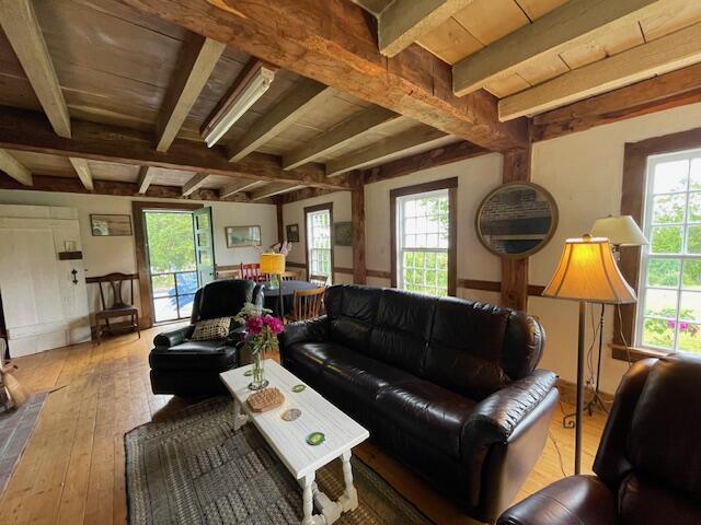 38 Kingsbury Ln, Perry, ME 04667 - living room featuring hardwood / wood-style flooring and beam ceiling