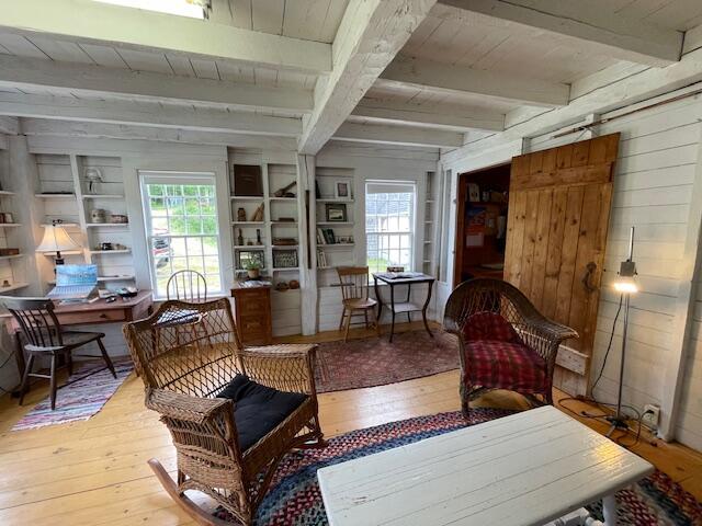 38 Kingsbury Ln, Perry, ME 04667 - sitting room featuring hardwood / wood-style flooring, wooden walls, and a wood ceiling with exposed beams