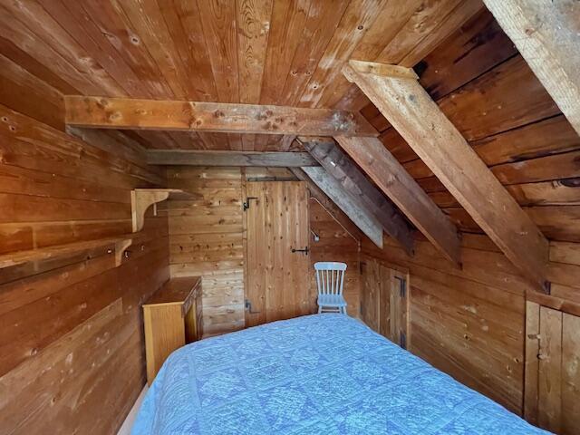 38 Kingsbury Ln, Perry, ME 04667 - bedroom featuring wood ceiling and wooden walls