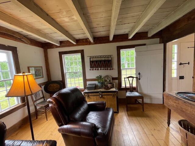 38 Kingsbury Ln, Perry, ME 04667 - sitting room with light wood-style floors, healthy amount of natural light, and a wood ceiling with exposed beams