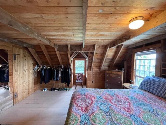 38 Kingsbury Ln, Perry, ME 04667 - bedroom featuring wood ceiling, multiple windows, wooden walls, vaulted ceiling, and hardwood / wood-style floors