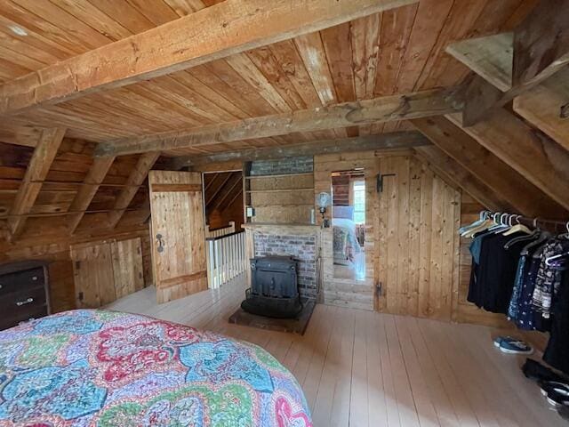 38 Kingsbury Ln, Perry, ME 04667 - unfurnished bedroom with wood ceiling, wood walls, hardwood / wood-style flooring, and a wood stove