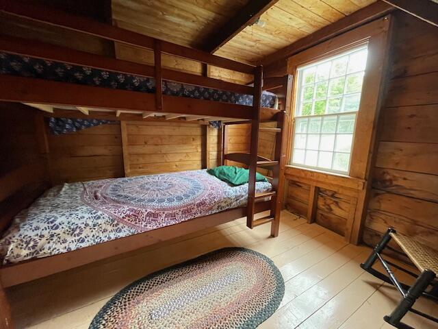 38 Kingsbury Ln, Perry, ME 04667 - bedroom with wood ceiling, wood walls, and wood-type flooring