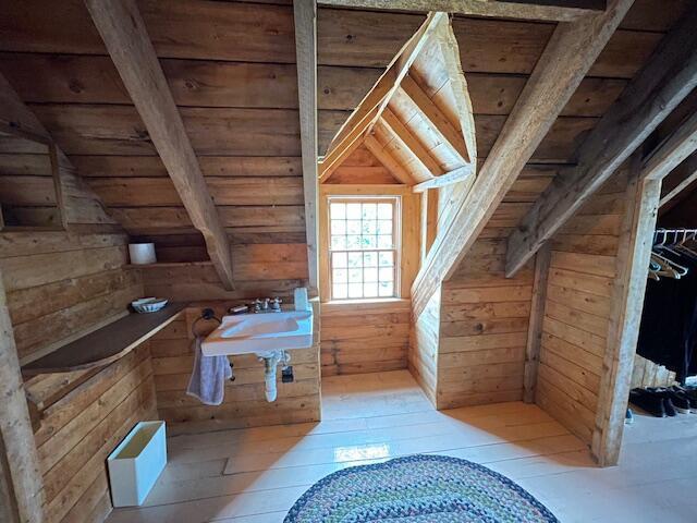 38 Kingsbury Ln, Perry, ME 04667 - bathroom featuring wood ceiling, wood walls, and hardwood / wood-style flooring