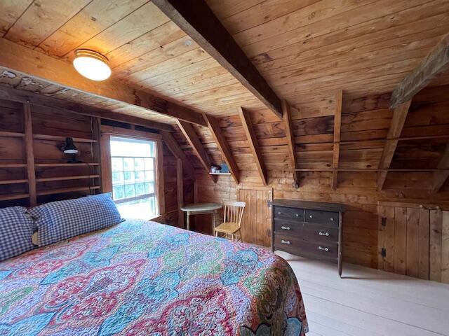 38 Kingsbury Ln, Perry, ME 04667 - bedroom featuring wood ceiling, wooden walls, and wood-type flooring