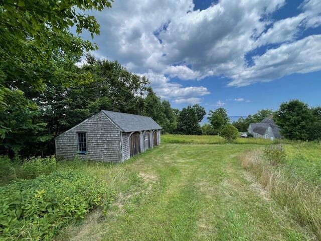 38 Kingsbury Ln, Perry, ME 04667 - view of yard featuring a garage and an outbuilding