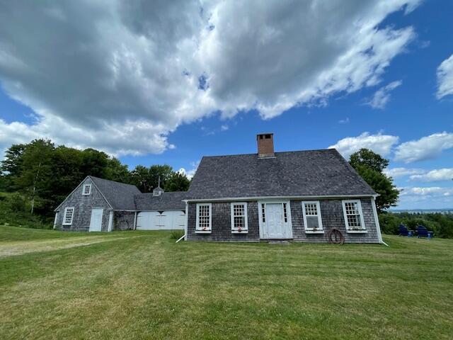 38 Kingsbury Ln, Perry, ME 04667 - rear view of house featuring a lawn and a chimney