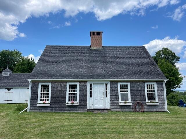 38 Kingsbury Ln, Perry, ME 04667 - view of front facade with a chimney, a front lawn, and a shingled roof
