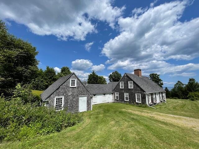 38 Kingsbury Ln, Perry, ME 04667 - view of property exterior featuring a lawn and a chimney