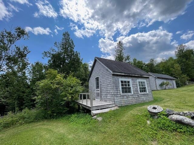 38 Kingsbury Ln, Perry, ME 04667 - view of side of home featuring a wooden deck and a yard