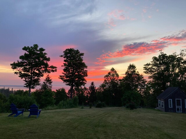 38 Kingsbury Ln, Perry, ME 04667 - yard at dusk with an outbuilding and a lawn