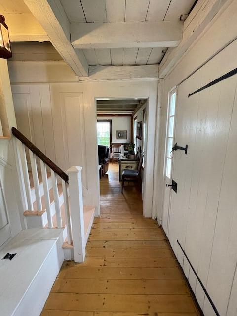 38 Kingsbury Ln, Perry, ME 04667 - hall with beam ceiling, light wood-type flooring, and stairs