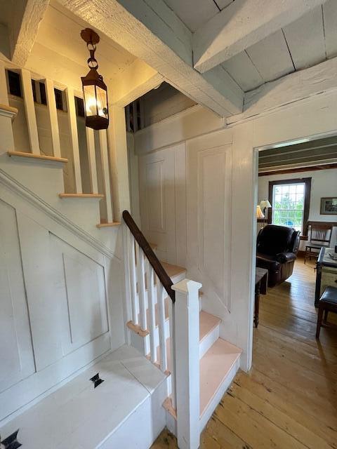 38 Kingsbury Ln, Perry, ME 04667 - stairway with wood-type flooring and beam ceiling