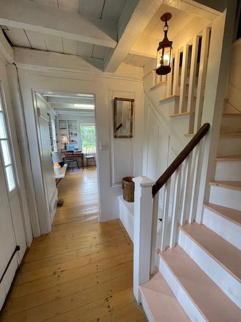 38 Kingsbury Ln, Perry, ME 04667 - hallway featuring hardwood / wood-style floors, stairway, and beam ceiling