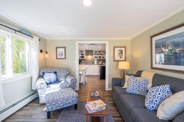 living room with a baseboard heating unit, dark hardwood / wood-style flooring, a wealth of natural light, and ornamental molding