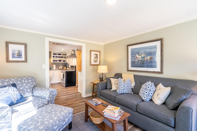 living room with ornamental molding and hardwood / wood-style floors