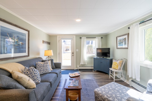 living room with plenty of natural light, dark hardwood / wood-style floors, and a baseboard heating unit