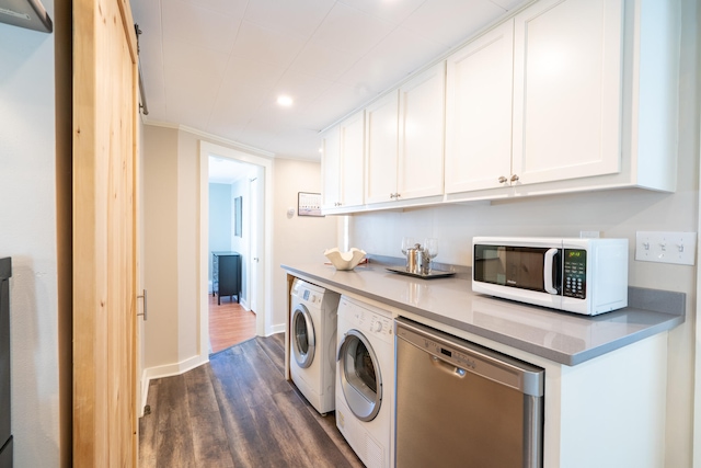 laundry area featuring washing machine and dryer, crown molding, and dark hardwood / wood-style floors