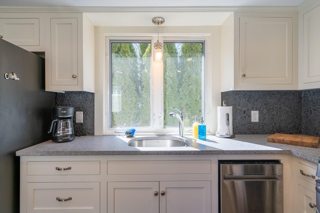 kitchen with sink, white cabinets, and backsplash