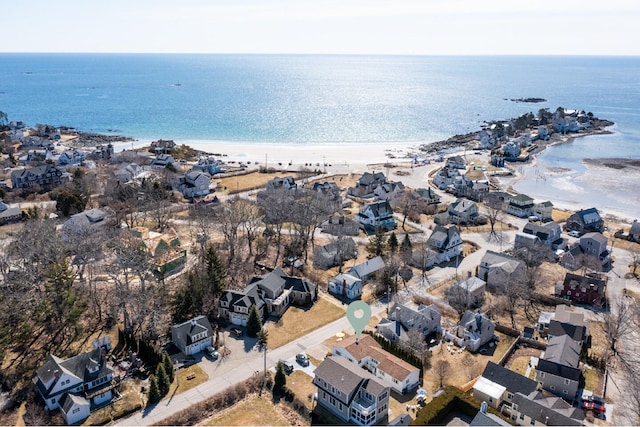 birds eye view of property with a water view and a view of the beach